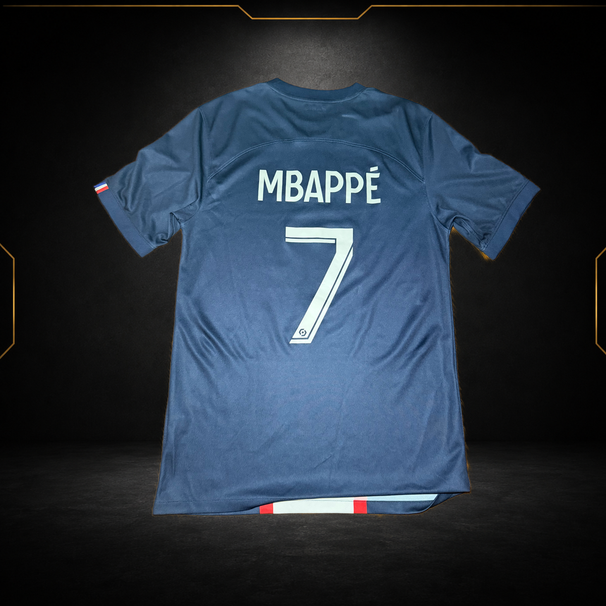 Back of a PSG 2022/23 home shirt already printed with Mbappé 7, photographed for the Maillots Market catalogue